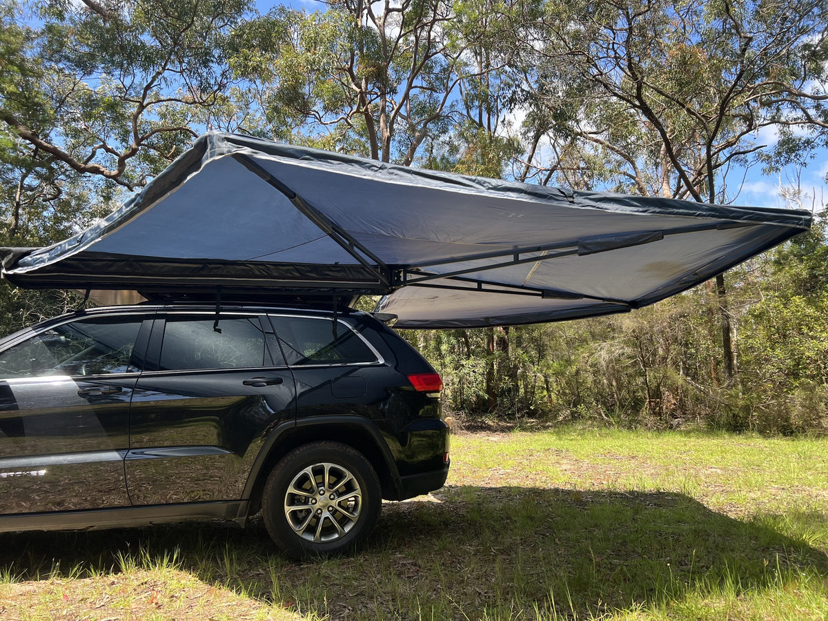 Vantura freestanding awning open beside the vehicle at camp