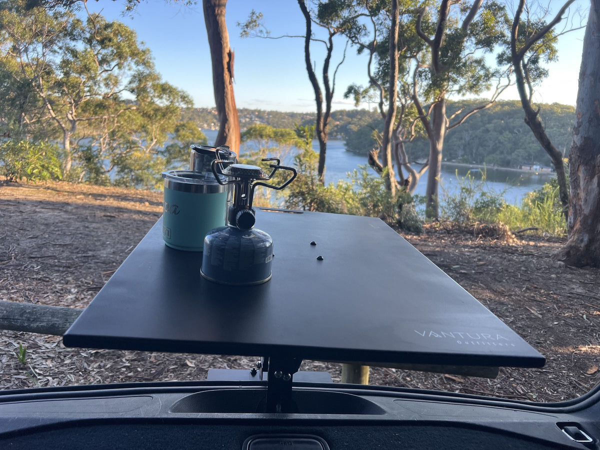Coffee gear on the metal Bootlid table with a lake view